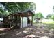 Exterior view of home with a covered porch, small shed and lush green yard at 416 E Union St, Marshville, NC 28103