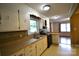 Galley kitchen featuring laminate countertops, wood backsplash, and black appliances at 416 E Union St, Marshville, NC 28103