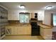 Galley kitchen featuring laminate countertops, wood backsplash, and black appliances at 416 E Union St, Marshville, NC 28103