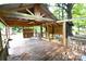 Outdoor deck with partially covered structure surrounded by mature trees at 416 E Union St, Marshville, NC 28103