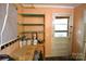 Storage room featuring a work bench, utility shelving, and an exterior door at 416 E Union St, Marshville, NC 28103