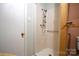 Bathroom featuring a walk-in shower with a hand-held shower head and a white door at 416 E Union St, Marshville, NC 28103