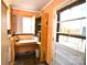 Bright utility room boasts exterior access, workbench, shelves, and speckled flooring at 416 E Union St, Marshville, NC 28103