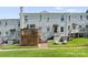 Exterior view of a home with a wooden deck, steps, and grassy backyard at 504 Wakefield Dr # A, Charlotte, NC 28209
