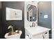 Stylish bathroom with dark accent wall, white vanity, and modern fixtures at 504 Wakefield Dr # A, Charlotte, NC 28209