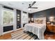 Stylish bedroom with dark accent wall, ceiling fan, and hardwood floors at 504 Wakefield Dr # A, Charlotte, NC 28209