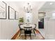 Charming dining area with modern light fixture and view to the kitchen at 504 Wakefield Dr # A, Charlotte, NC 28209
