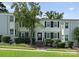 Inviting townhome featuring a well-maintained lawn and classic black shutters at 504 Wakefield Dr # A, Charlotte, NC 28209