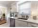 Bright kitchen featuring white cabinets, stainless steel appliances, and modern fixtures at 504 Wakefield Dr # A, Charlotte, NC 28209