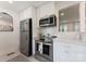 Cozy kitchen with stainless steel appliances, white cabinets, and decorative backsplash at 504 Wakefield Dr # A, Charlotte, NC 28209