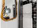 Convenient laundry closet with stacked washer and dryer and a decorative mirror at 504 Wakefield Dr # A, Charlotte, NC 28209