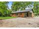 Exterior view of home featuring a brick facade, covered patio, and expansive backyard at 5320 Kildare Dr, Charlotte, NC 28215