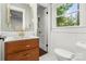 Bathroom featuring modern fixtures, a wood vanity, and natural light at 5320 Kildare Dr, Charlotte, NC 28215
