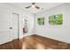 Bedroom featuring hardwood floors, fresh paint, natural light, and an ensuite bathroom at 5320 Kildare Dr, Charlotte, NC 28215
