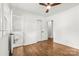 Bedroom with hardwood floors, fresh paint, modern ceiling fan, and ensuite bathroom at 5320 Kildare Dr, Charlotte, NC 28215