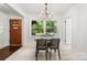 Bright dining room with modern chandelier and a large window with backyard views at 5320 Kildare Dr, Charlotte, NC 28215