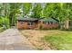 Inviting brick home with manicured lawn, showcasing its curb appeal at 5320 Kildare Dr, Charlotte, NC 28215