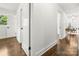 Hallway with hardwood floors, fresh paint, and modern light fixtures at 5320 Kildare Dr, Charlotte, NC 28215