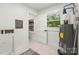 Bright utility room featuring water heater, electrical box and window allowing natural light at 5320 Kildare Dr, Charlotte, NC 28215