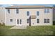 Home's back exterior features a patio, neutral siding, and multiple windows at 5805 Lindley Crescent Dr, Indian Trail, NC 28079
