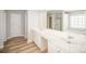 Bright bathroom featuring dual sinks, ample vanity space, and wood-look flooring at 5805 Lindley Crescent Dr, Indian Trail, NC 28079