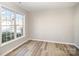 Bright bedroom featuring a large window and wood-look flooring at 5805 Lindley Crescent Dr, Indian Trail, NC 28079