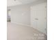 Spacious bedroom featuring neutral carpeting and paint, with a glimpse of a bathroom and a closet at 5805 Lindley Crescent Dr, Indian Trail, NC 28079
