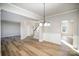 Open-concept dining room showcasing wainscoting and wood-look flooring at 5805 Lindley Crescent Dr, Indian Trail, NC 28079