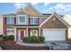 Charming two-story home features a brick and siding exterior, a two-car garage, and a well-manicured lawn at 5805 Lindley Crescent Dr, Indian Trail, NC 28079
