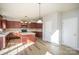 Bright kitchen features dark cabinetry, a center island, and modern lighting at 5805 Lindley Crescent Dr, Indian Trail, NC 28079