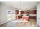 Well-lit kitchen with dark cabinets, a center island, and stainless steel appliances at 5805 Lindley Crescent Dr, Indian Trail, NC 28079