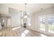 Bright living room with hardwood floors, fireplace, tall windows and access to the backyard at 5805 Lindley Crescent Dr, Indian Trail, NC 28079
