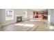 Bright living room with hardwood floors, a fireplace, and an open layout to the kitchen with stainless appliances at 5805 Lindley Crescent Dr, Indian Trail, NC 28079