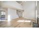 Large living room with vaulted ceiling, fireplace, hardwood floors, and neutral paint at 5805 Lindley Crescent Dr, Indian Trail, NC 28079