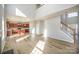 Spacious living room with high ceilings, hardwood floors, and lots of natural light, with a modern kitchen in view at 5805 Lindley Crescent Dr, Indian Trail, NC 28079