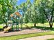 Community playground featuring slides, swings, and climbing structure surrounded by green space at 5805 Lindley Crescent Dr, Indian Trail, NC 28079