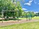 Swings and playground structures on a mulch ground in a grassy neighborhood park at 5805 Lindley Crescent Dr, Indian Trail, NC 28079