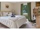 Inviting bedroom features a comfy bed, soft lighting, backyard views, and a desk area at 5922 Sullins Rd, Charlotte, NC 28214