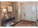 Inviting entryway with brick accent wall, decorative console table, and stylish front door with stained glass at 5922 Sullins Rd, Charlotte, NC 28214