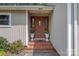 Warm and inviting front entryway with brick steps, flowerpots, and classic exterior details at 5922 Sullins Rd, Charlotte, NC 28214