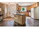 Bright kitchen featuring an island with barstool seating and ample cabinet space at 5922 Sullins Rd, Charlotte, NC 28214