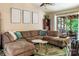 Relaxing living room with plush sofa, ceiling fan, and sliding door leading to the outside at 5922 Sullins Rd, Charlotte, NC 28214