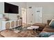 Comfortable living room boasts modern cabinet and opens to the kitchen and laundry area at 5922 Sullins Rd, Charlotte, NC 28214