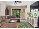 Inviting living room has neutral tones, access to the screened-in porch, and a modern media cabinet at 5922 Sullins Rd, Charlotte, NC 28214