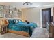 Bright bedroom has an impressive gallery wall, cozy carpet, complemented by an inviting blue comforter set at 5922 Sullins Rd, Charlotte, NC 28214