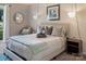 Bright main bedroom features pendant lighting, modern decor, and a plush upholstered headboard at 5922 Sullins Rd, Charlotte, NC 28214