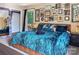 A bright bedroom with lots of wall art, complemented by a luxurious blue comforter and outdoor views at 5922 Sullins Rd, Charlotte, NC 28214