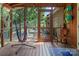 The screened-in porch has unique hammock chair and seating, plus view to outdoor dining space at 5922 Sullins Rd, Charlotte, NC 28214