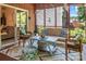 This screened-in porch has comfortable seating, colorful rugs, and great views of the lush backyard at 5922 Sullins Rd, Charlotte, NC 28214