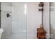 This elegant, bright white shower boasts new tilework, glass doors, and rustic wood bench at 5922 Sullins Rd, Charlotte, NC 28214